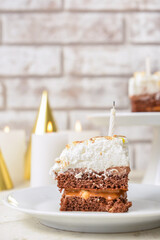 Plate with piece of tasty birthday cake on light table, closeup