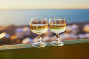 Two glasses of white wine with Atlantic coast beach in background
