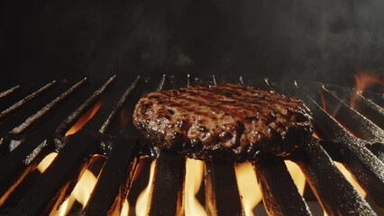 Close up shot of placing burger meat on grill and cooking it on fire