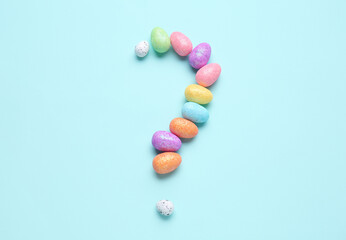 Fototapeta na wymiar Question mark made of decorative eggs on color background