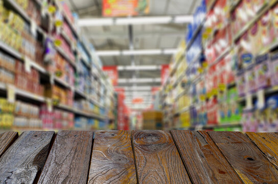 Old Teak Wood Empty Table In Front Of An Empty Supermarket Aisle