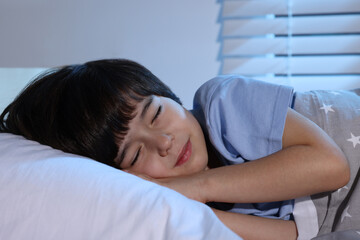 Obraz na płótnie Canvas Cute little boy sleeping in bed at home