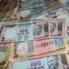 Old One Hundred Rupee notes combined on the table, India money on the rotating table. Old Indian Currency notes on a rotating table, Indian Currency on the table