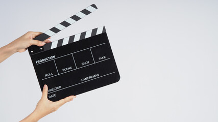 Hands is holding black Clapperboard or movie slate. it use in video production ,film, cinema...
