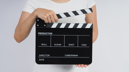 Hands is holding black Clapperboard or movie slate. it use in video production ,film, cinema...