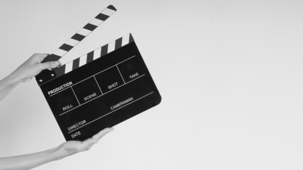 Hands is holding black Clapperboard or movie slate. it use in video production ,film, cinema...