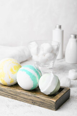 Wooden board with bath bombs on table
