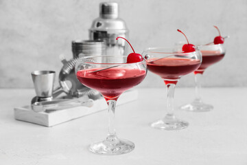 Glasses of tasty Manhattan cocktail on light background