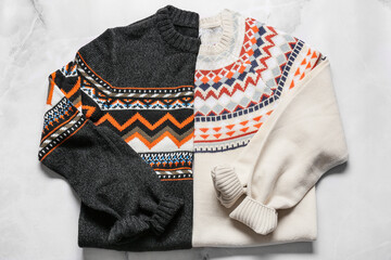 Different male sweaters on light background