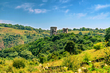 Fototapeta na wymiar View of old ruined fortress on hill. Mystical landscape.