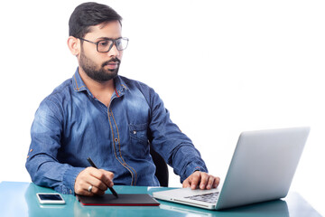 young graphic designer using stylus pen and digital tablet for drawing and editing in white background