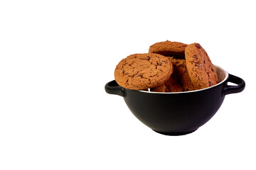 Cookies with cocoa and chocolate chips in a black plate on a white background