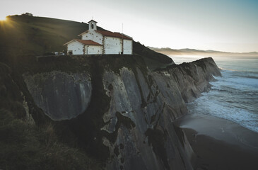 Small church on top of a cliff by the sea
