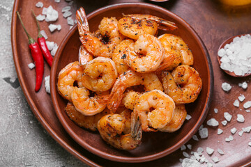 Plate of tasty shrimp tails on table