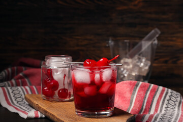 Glass of tasty Manhattan cocktail on table