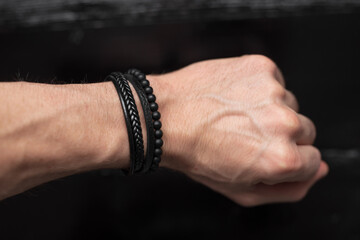 Black leather bracelet on the male hand - 481887856
