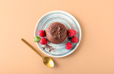 Plate with tasty lava cake fondant and raspberry on color background