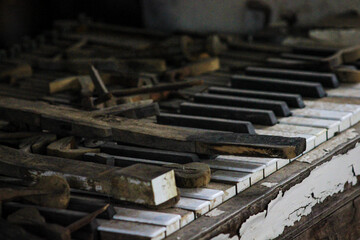 Old ruined piano in an abandoned house in the village shack close up of keys side angle