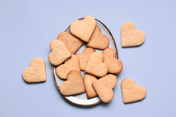 Plate with tasty heart shaped cookies on lilac background. Valentines Day celebration