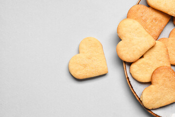 Plate with tasty heart shaped cookies on light background, closeup. Valentines Day celebration