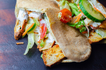 Mediterranean style pitta prepared with spicy chicken, cucumber, tomato, salad and mayo sauce