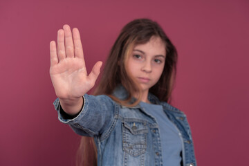 Girl showing stop gesture in studio
