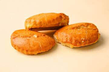 Tasty sochniki with cottage cheese on beige background