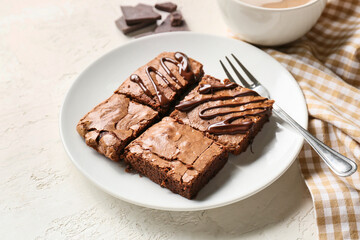 Plate with pieces of tasty chocolate brownie on white background