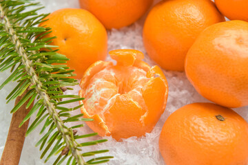 Tasty tangerines and snow on table, closeup
