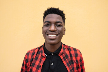 Obraz premium Portrait of happy young African teenager smiling in front of camera