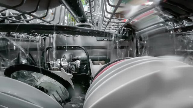 Washing dishes process inside the dishwasher