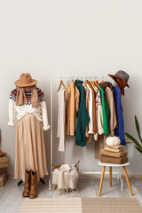 Interior of dressing room with mannequin, rack and warm sweaters