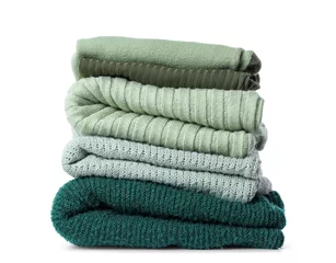 Tuinposter Stack of knitted sweaters on white background © Pixel-Shot