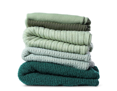 Stack of knitted sweaters on white background