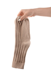 Woman holding pair of socks on white background