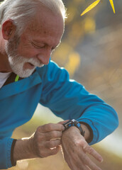 Senior man using smart watch while exercise