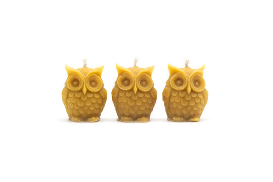 Isolated photos of handmade beeswax candles in the shape of an owl