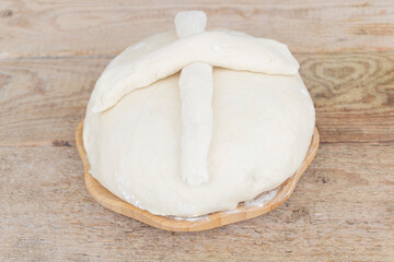 Some fresh dough in a wooden plate