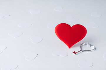 red heart with a heart-shaped key on a white background with white hearts