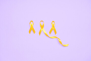 Golden awareness ribbons on violet background. International Childhood Cancer Day