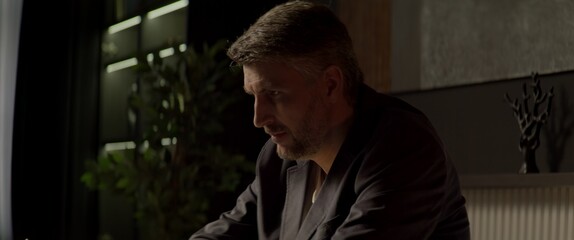 CU Portrait of 40s Thoughtful Caucasian businessman working on a laptop in the office. Shot with 2x...
