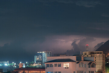 Fototapeta premium Night thunderstorm over the city in mountains