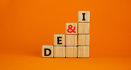 DEI, Diversity, equity and inclusion symbol. Concept words DEI, diversity, equity and inclusion on wooden cubes on beautiful orange background. Business, DEI, diversity, equity and inclusion concept.