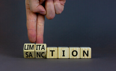 Sanction and limitation symbol. Businessman turns cubes, changes the word limitation to sanction....