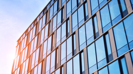 Modern glass corporate architecture with reflection of sky on the facade a sunny day