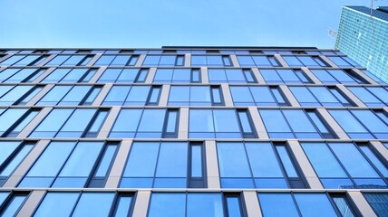 Modern glass corporate architecture with reflection of sky on the facade a sunny day