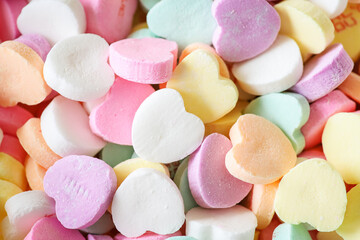 Colorful pile of pastel candy hearts for Valentine's Day.