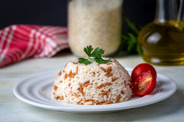 Turkish traditional food; Rice pilaf with barley noodles on a white background (Turkish name; Arpa sehriyeli pirinc pilavi)