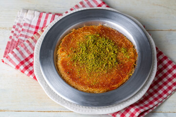Delicious traditional Turkish kunefe with pistachio on it. Served hot and with syrup