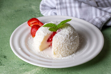 Delicious milk dessert; cup dessert with coconut and strawberry (Turkish name; fincan tatlisi